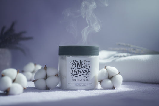 Candle jar with black lid and white label on a light gray background