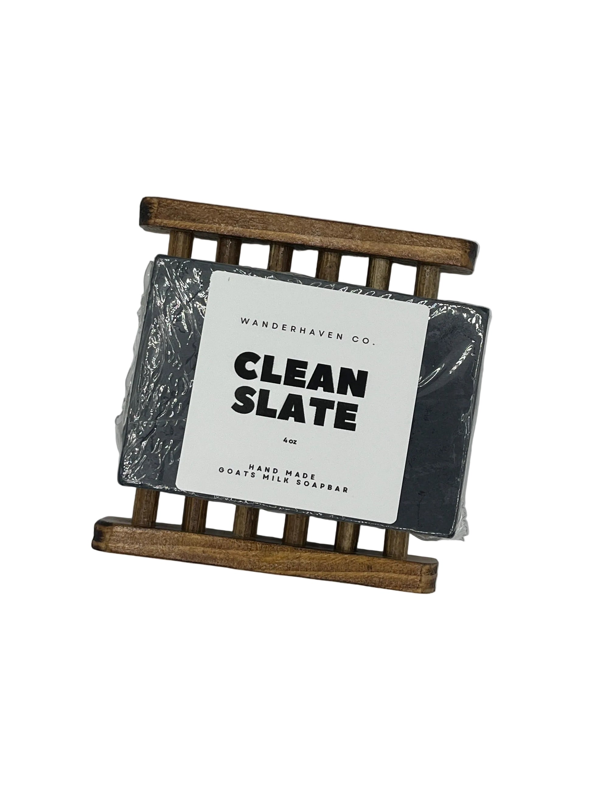 Bar of soap with 'Clean Slate' label on a wooden soap dish against a white background