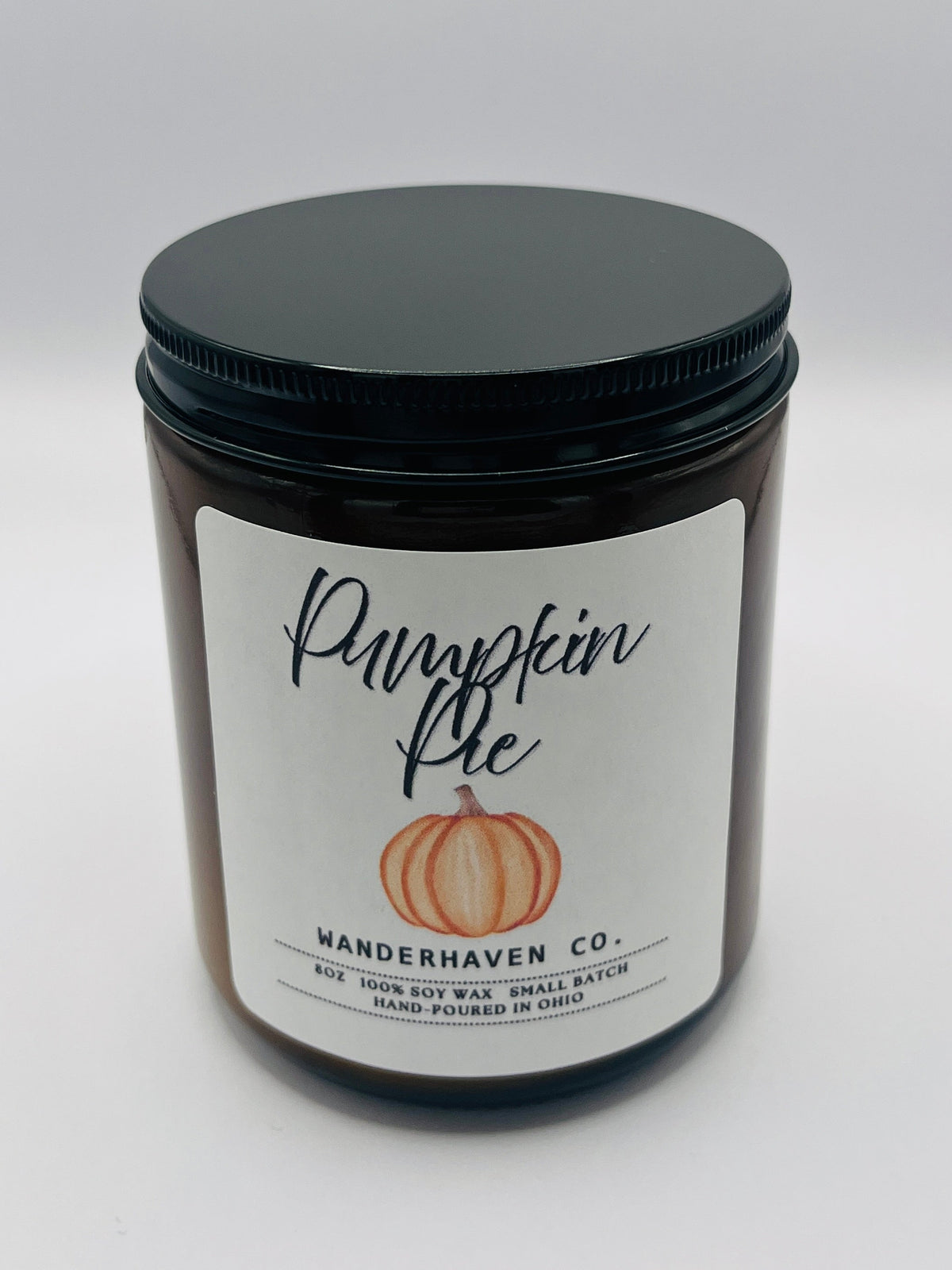 Amber Glass with black lid. Labels is white and says Pumpkin Pie with a picture of a pumpkin in the middle. 8oz, 100% soy wax, small batch made Ohio.